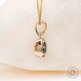 Angled view cushion moissanite pendant in yellow gold bezel
