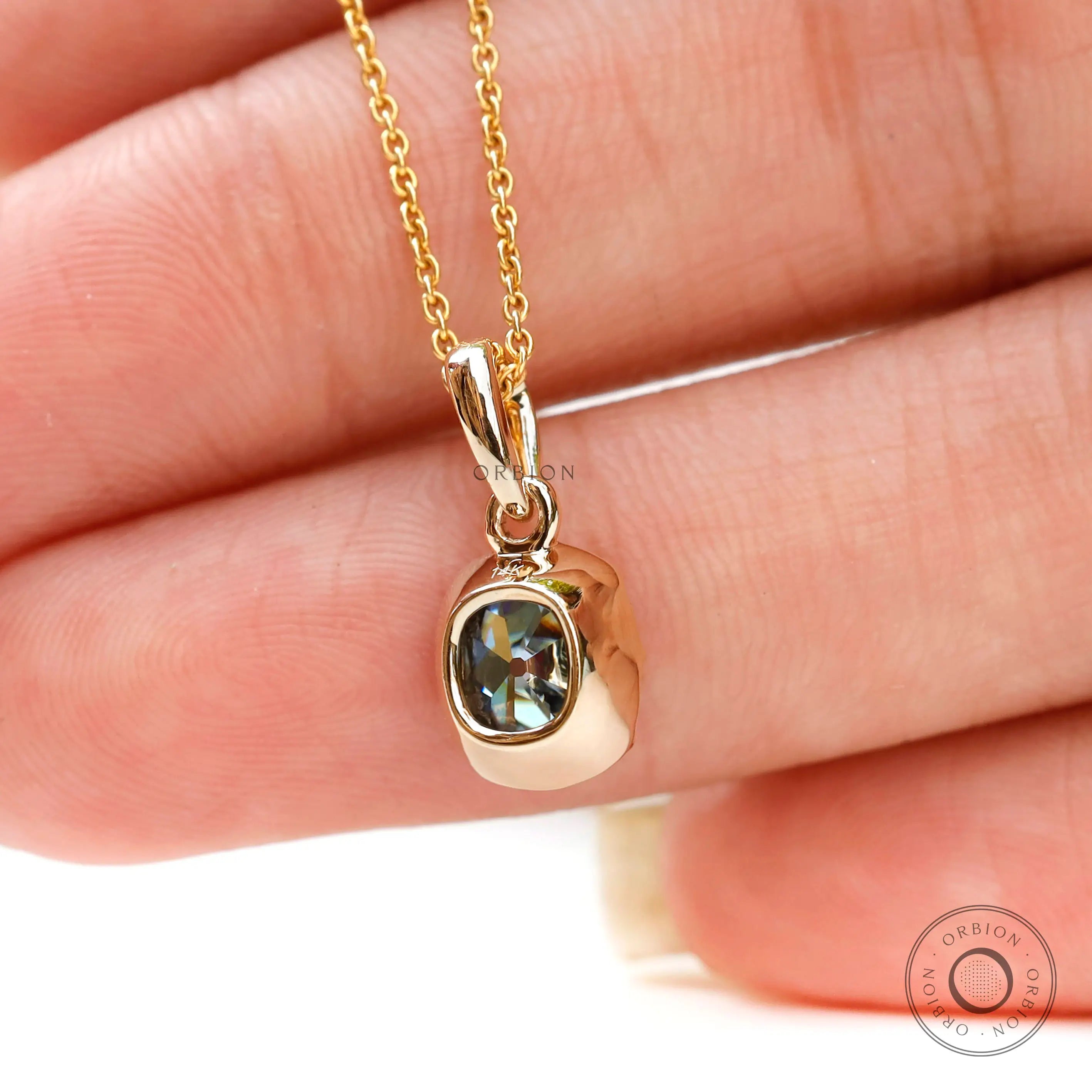 Back hand view moissanite pendant bezel set yellow gold