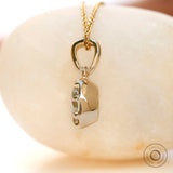 Angled view cushion moissanite pendant in yellow gold bezel