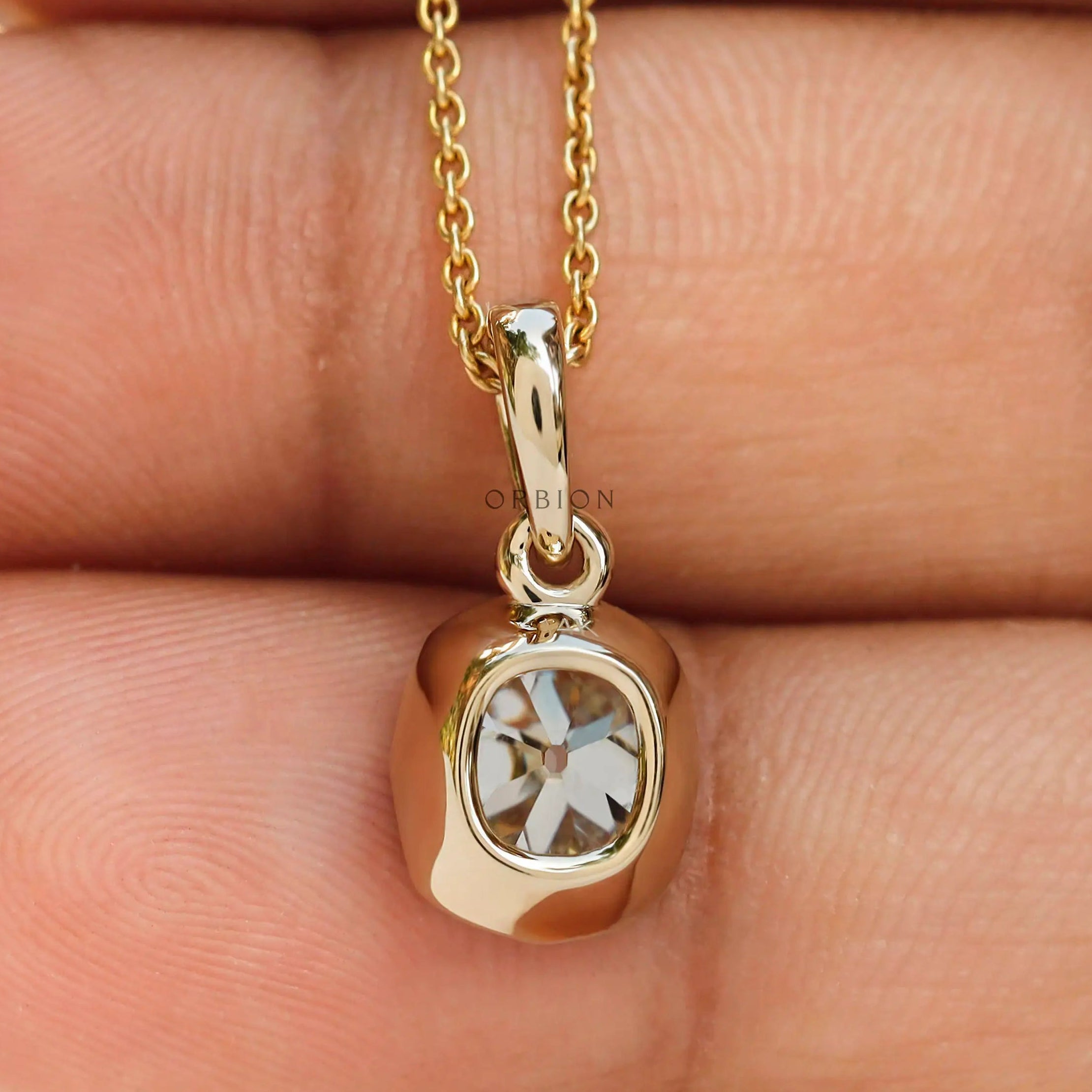 Back hand view moissanite pendant bezel set yellow gold