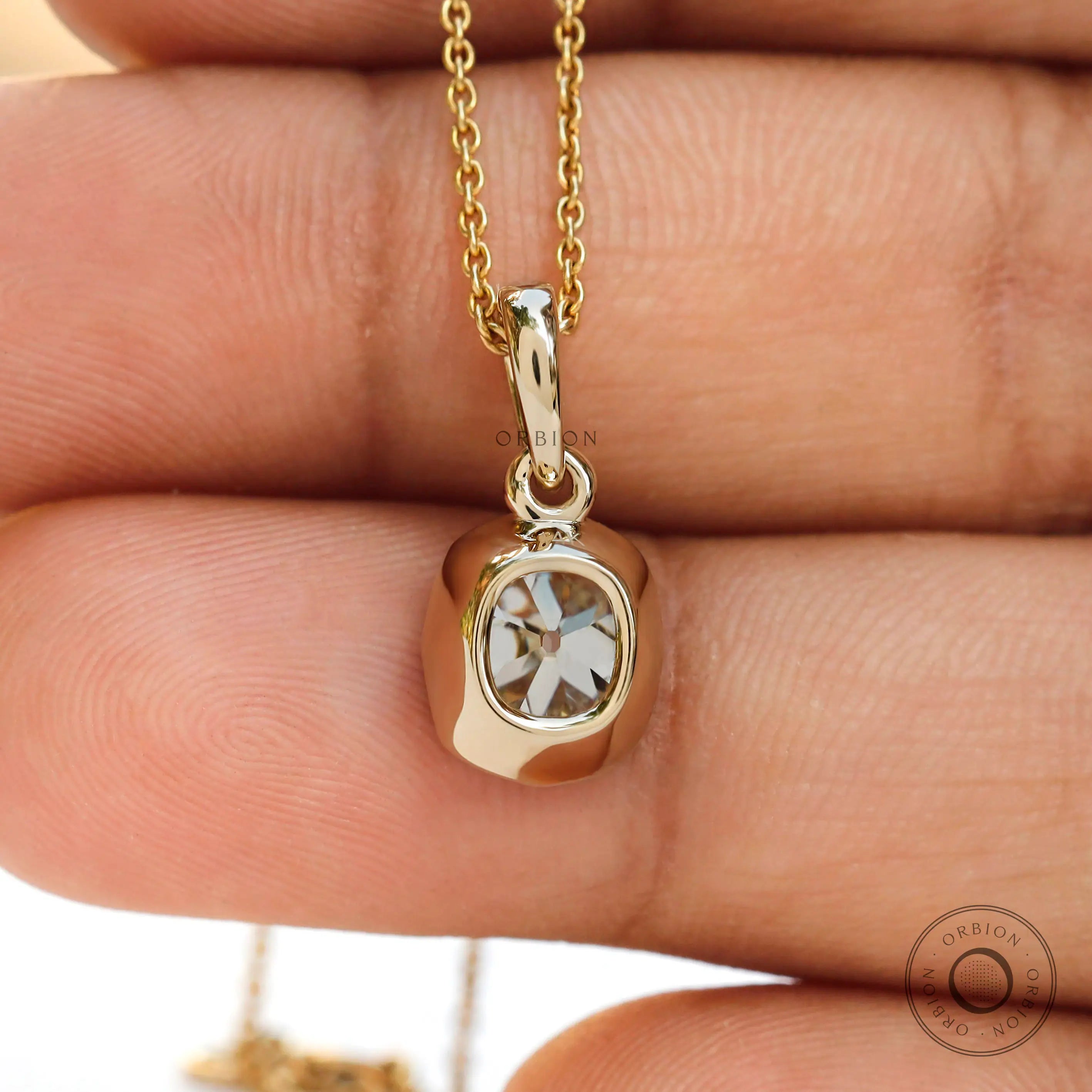 Back hand view moissanite pendant bezel set yellow gold