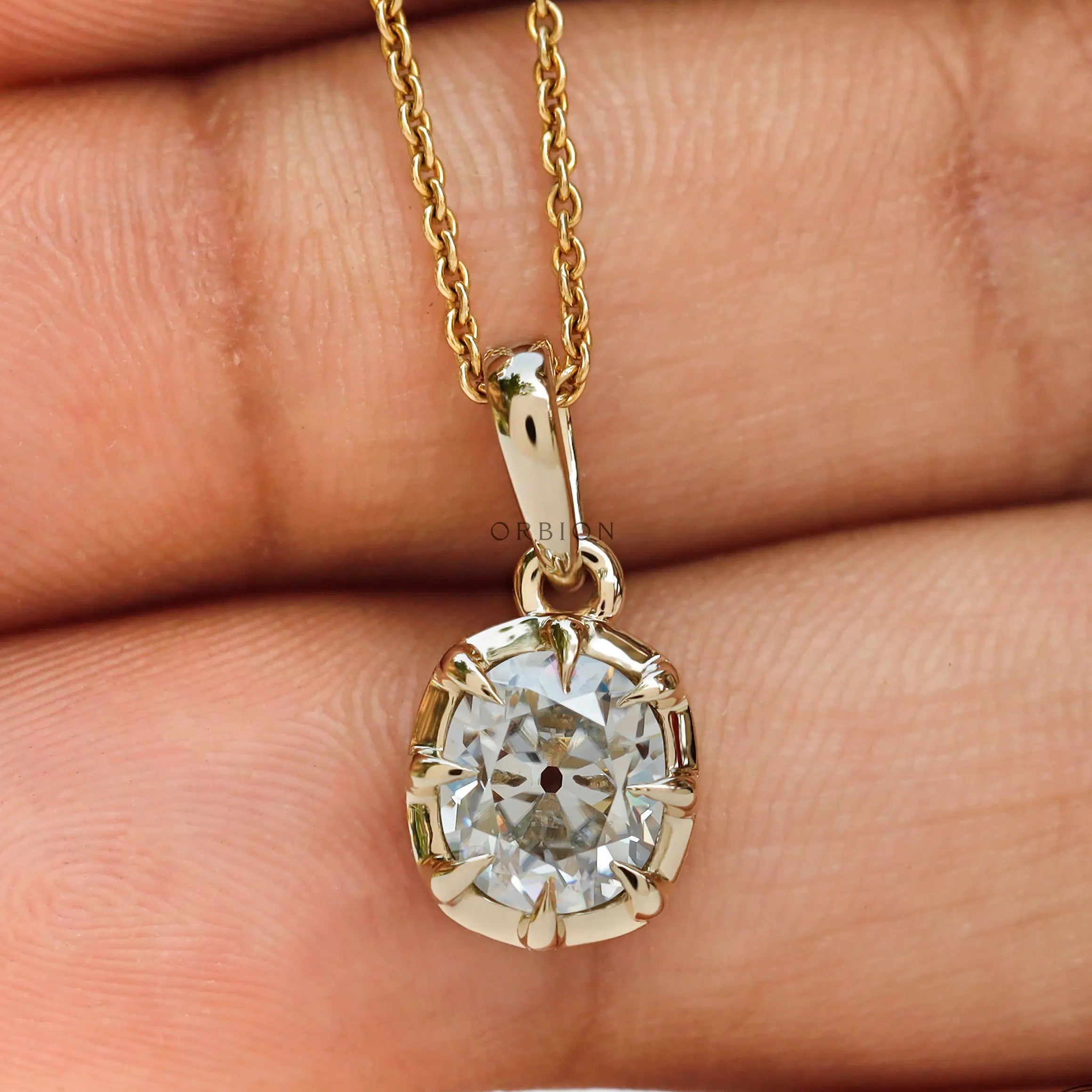 Front hand view old mine cut moissanite pendant yellow gold
