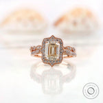 Front view of elegant emerald cut Moissanite halo ring in 14K rose gold