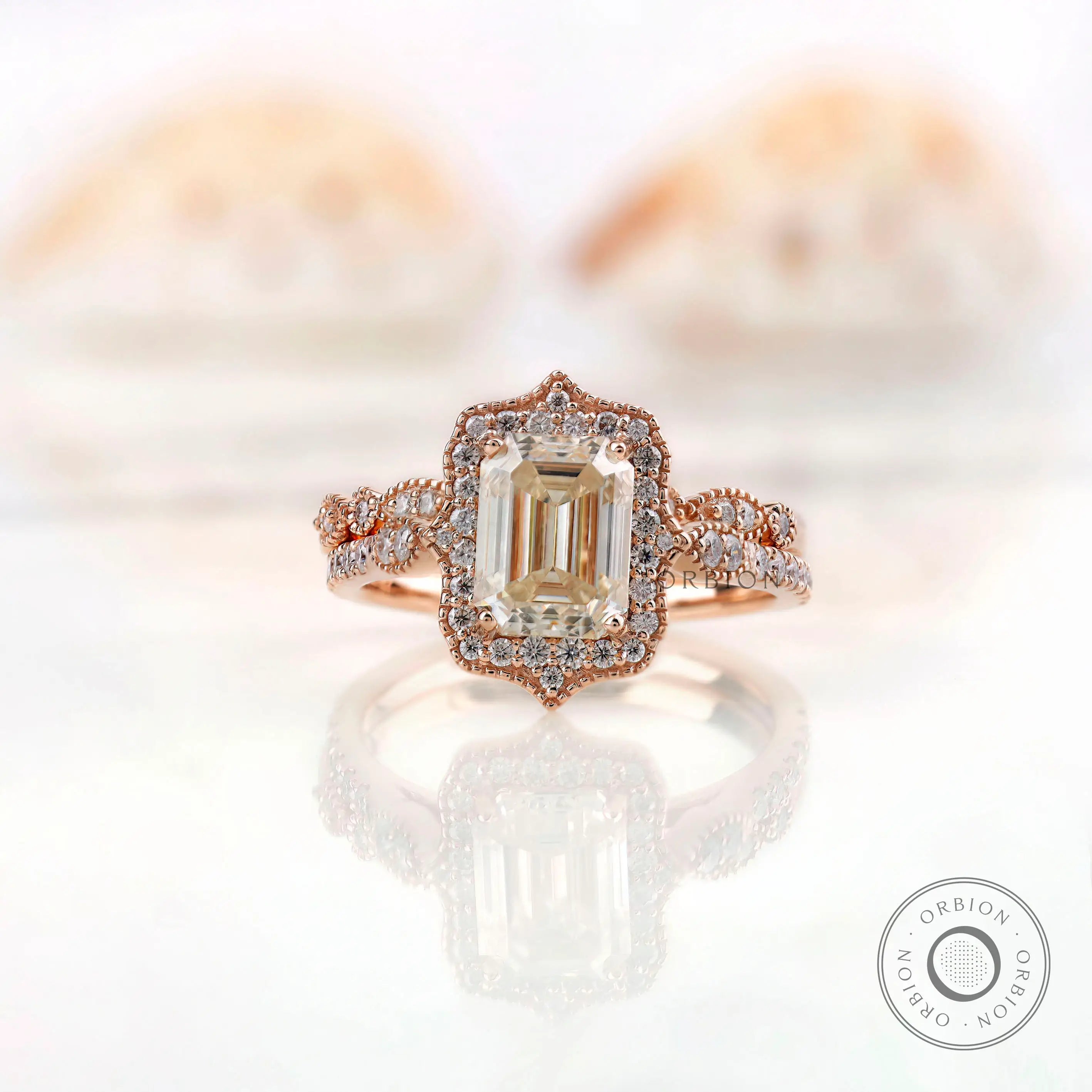 Front view of elegant emerald cut Moissanite halo ring in 14K rose gold