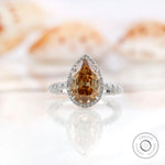 Pear Moissanite Old Mine Cut halo ring with round side stones in 14K white gold