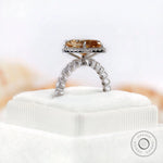 Pear-shaped Moissanite halo ring with side stones in white gold, showcasing the elegant design.