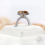 Pear-shaped Moissanite halo ring with side stones in white gold, showcasing the elegant design.