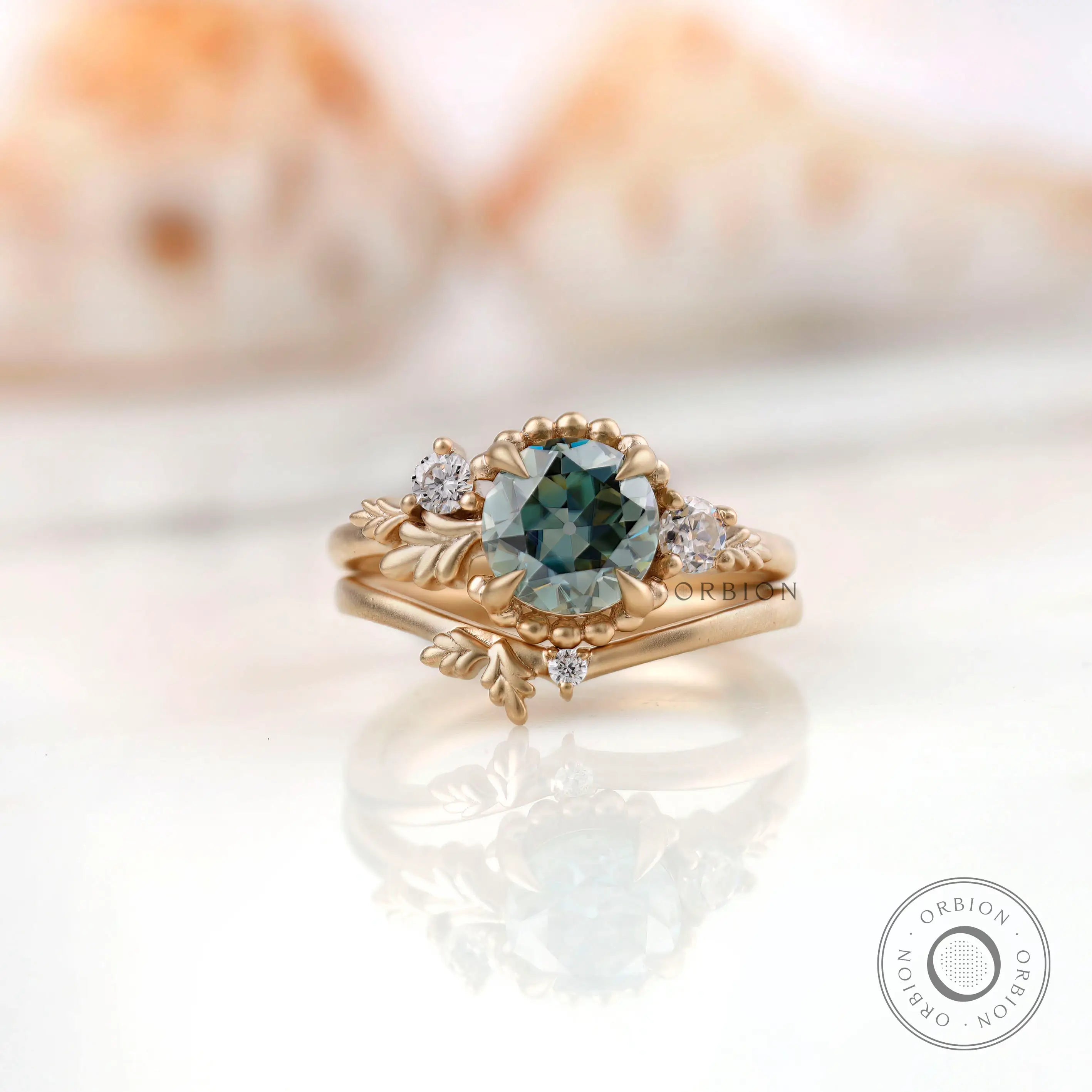 Front view of OEC Blue Green Moissanite ring in 10K matte gold.