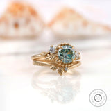 Angled view of OEC Moissanite ring set with leaf motif in gold.