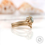 Side view showing intricate leaf motif setting with OEC Moissanite.