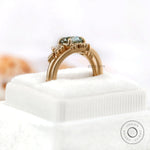 OEC Blue Green Moissanite ring placed on a soft ring box.