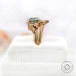 OEC Blue Green Moissanite ring showcasing side view on soft ring box.