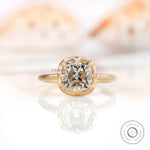 Elegant square cushion Old Mine Cut GHI moissanite solitaire bezel set engagement ring in 10K yellow gold.