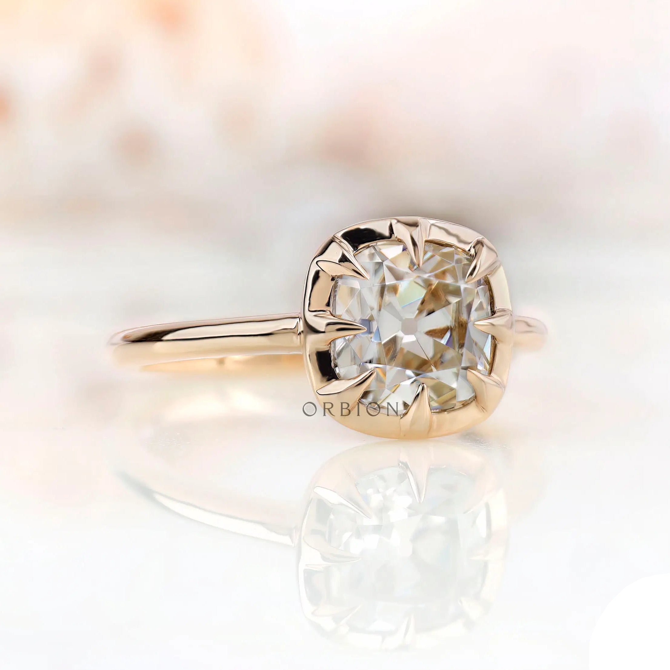 Angled view of cushion moissanite solitaire ring in 10K yellow gold