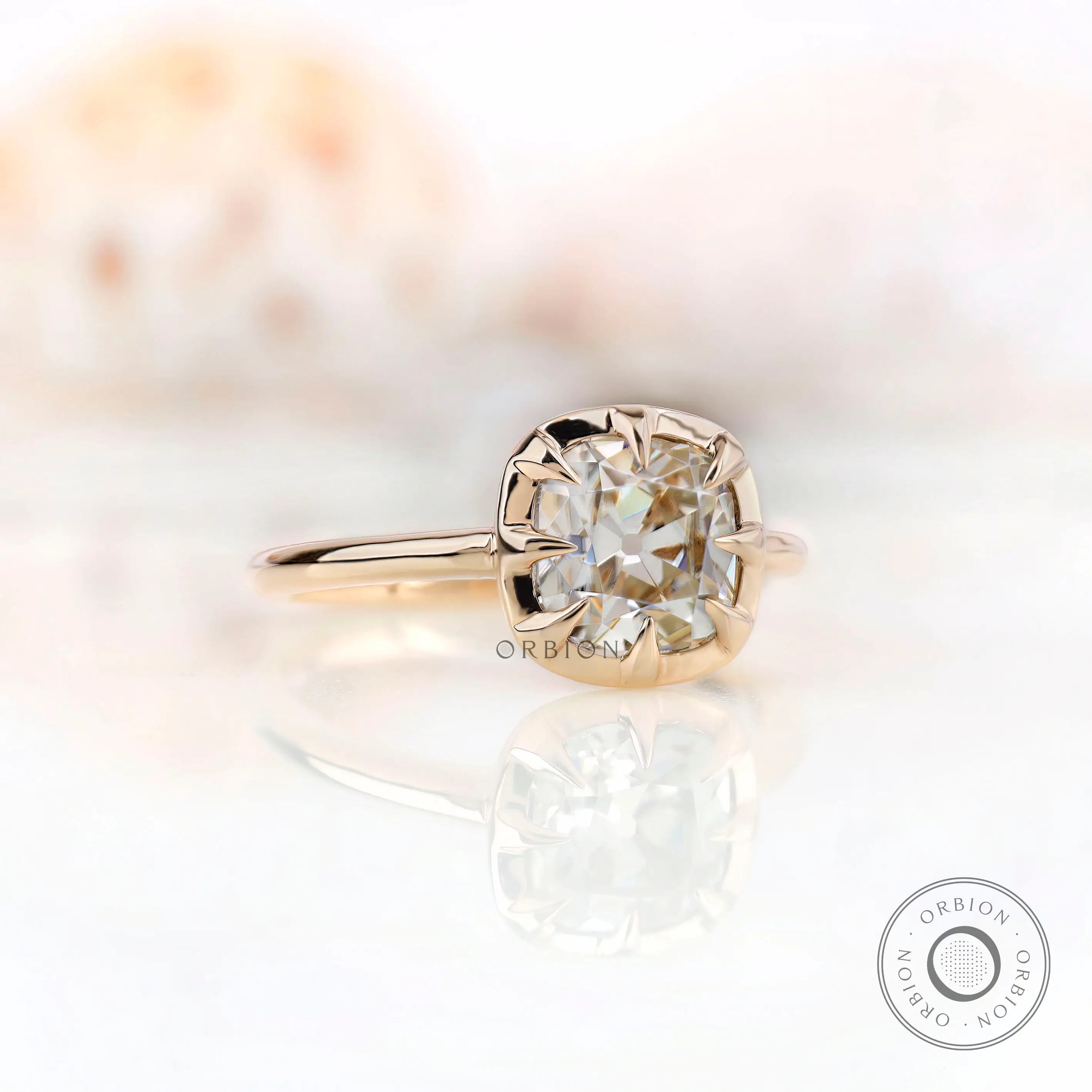 Angled view of cushion moissanite solitaire ring in 10K yellow gold