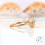Side profile highlighting the bezel setting and matte yellow gold band of the square cushion GHI moissanite ring.