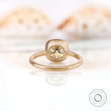 Back view of the square cushion GHI moissanite solitaire bezel set engagement ring in 10K yellow gold.