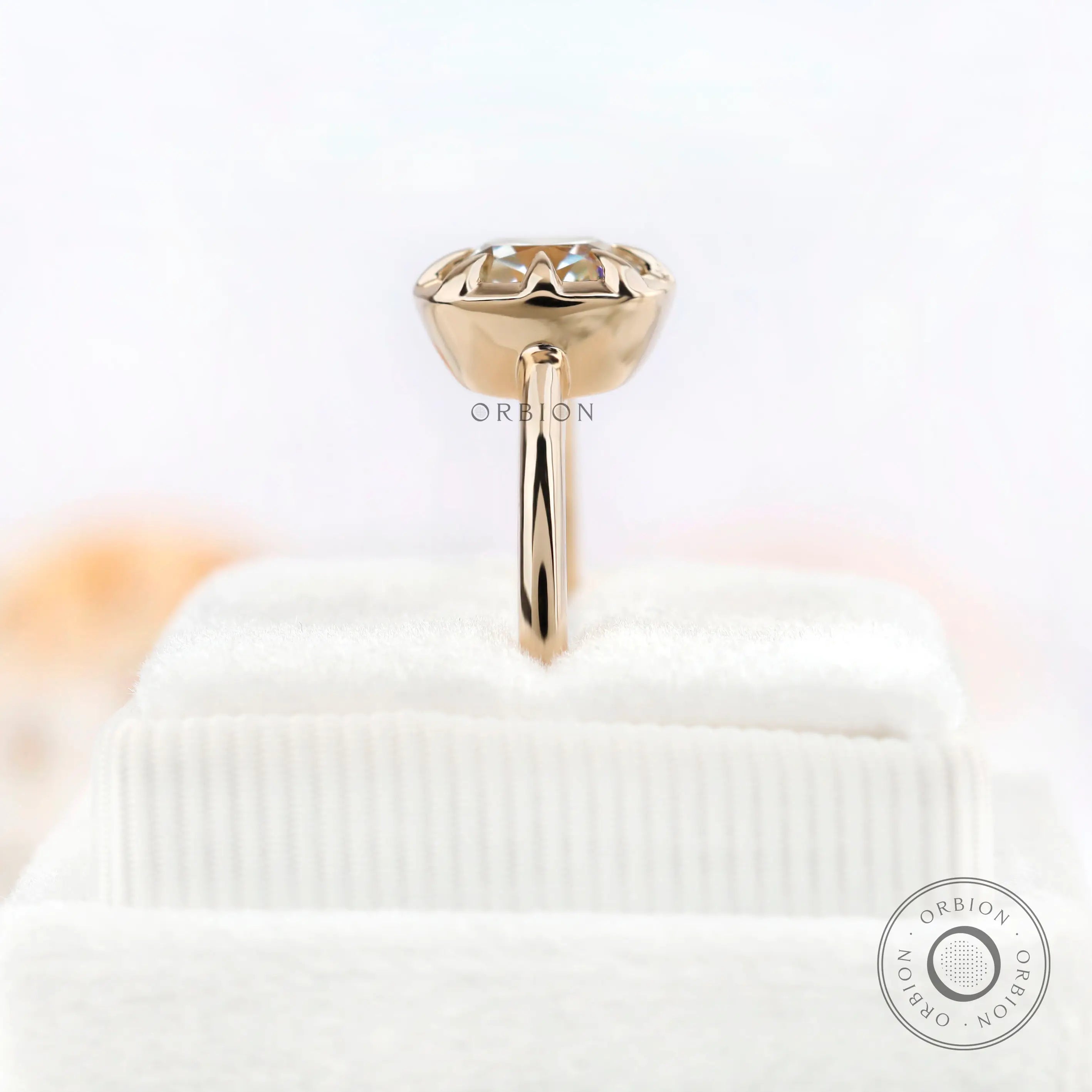 Profile view of yellow gold solitaire moissanite ring