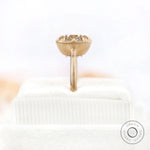 Matte 10K yellow gold solitaire square cushion GHI moissanite engagement ring worn on hand.
