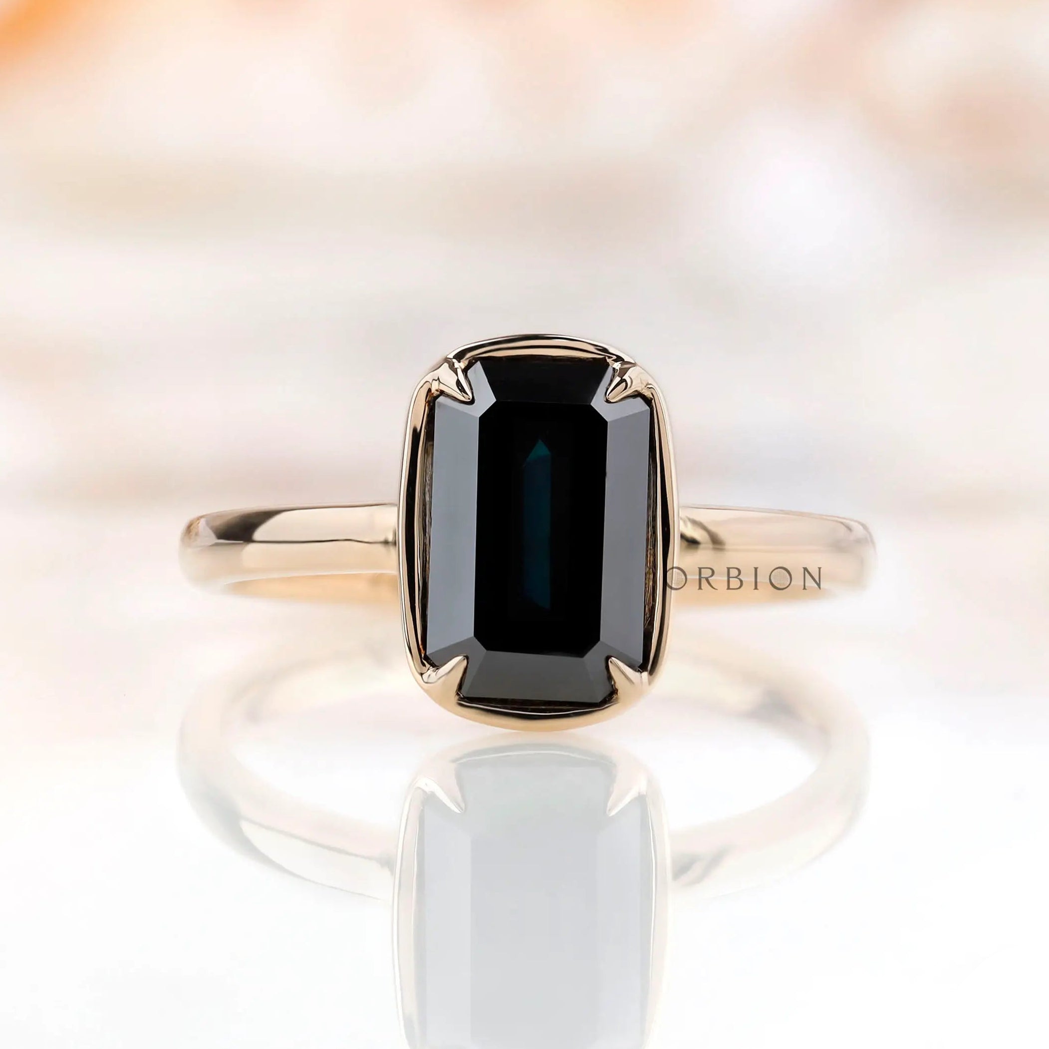 Front view of emerald cut black green moissanite solitaire engagement ring