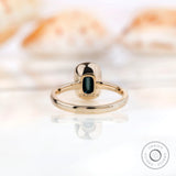 Back view of solitaire emerald cut black green moissanite engagement ring