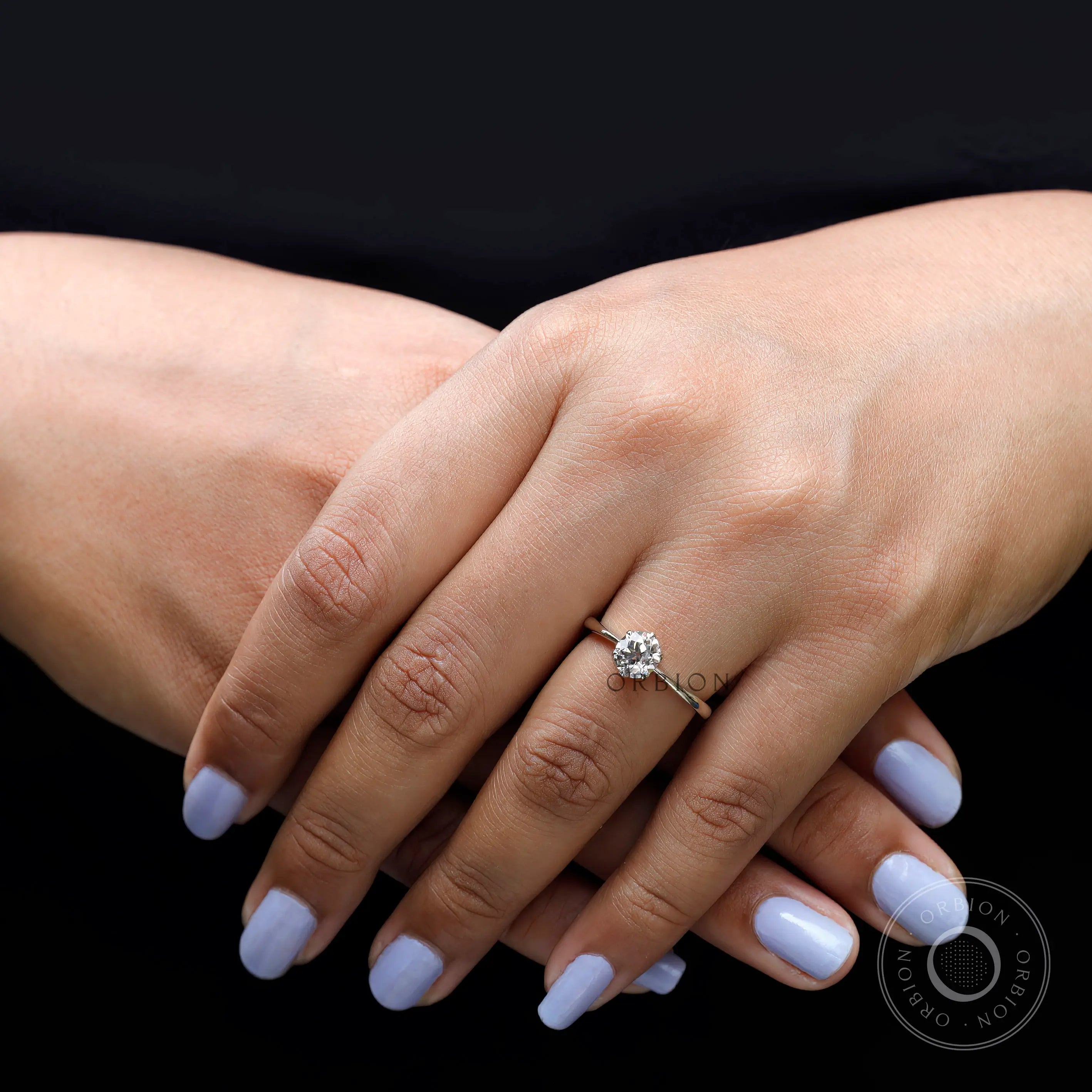 Solitaire diamond ring worn on hand top view