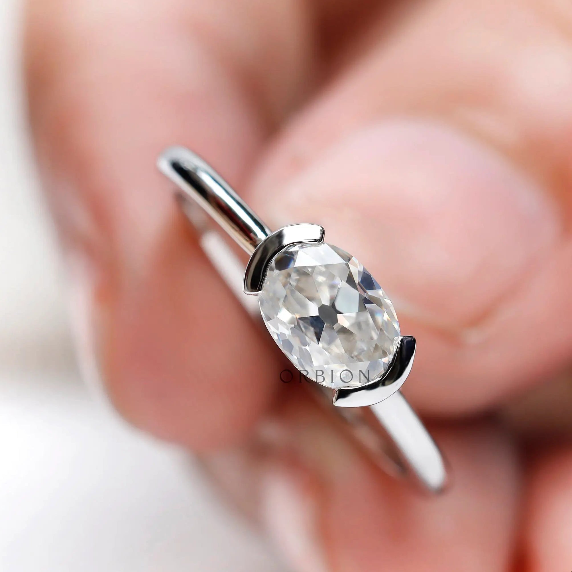 Minimalist oval moissanite dainty ring white gold top view