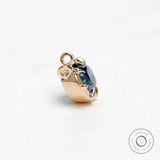 Double loop yellow gold pendant with oval blue stone