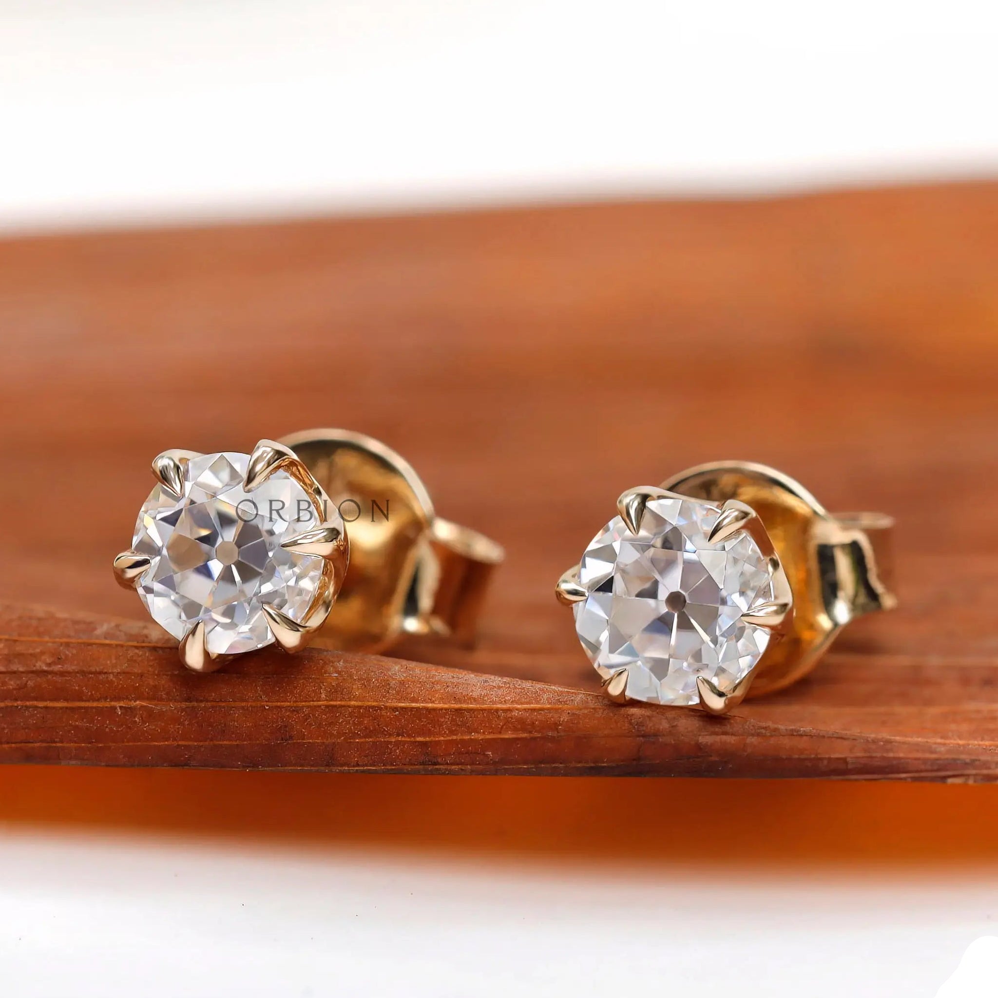 Angled view highlighting vintage cut moissanite brilliance of ear studs