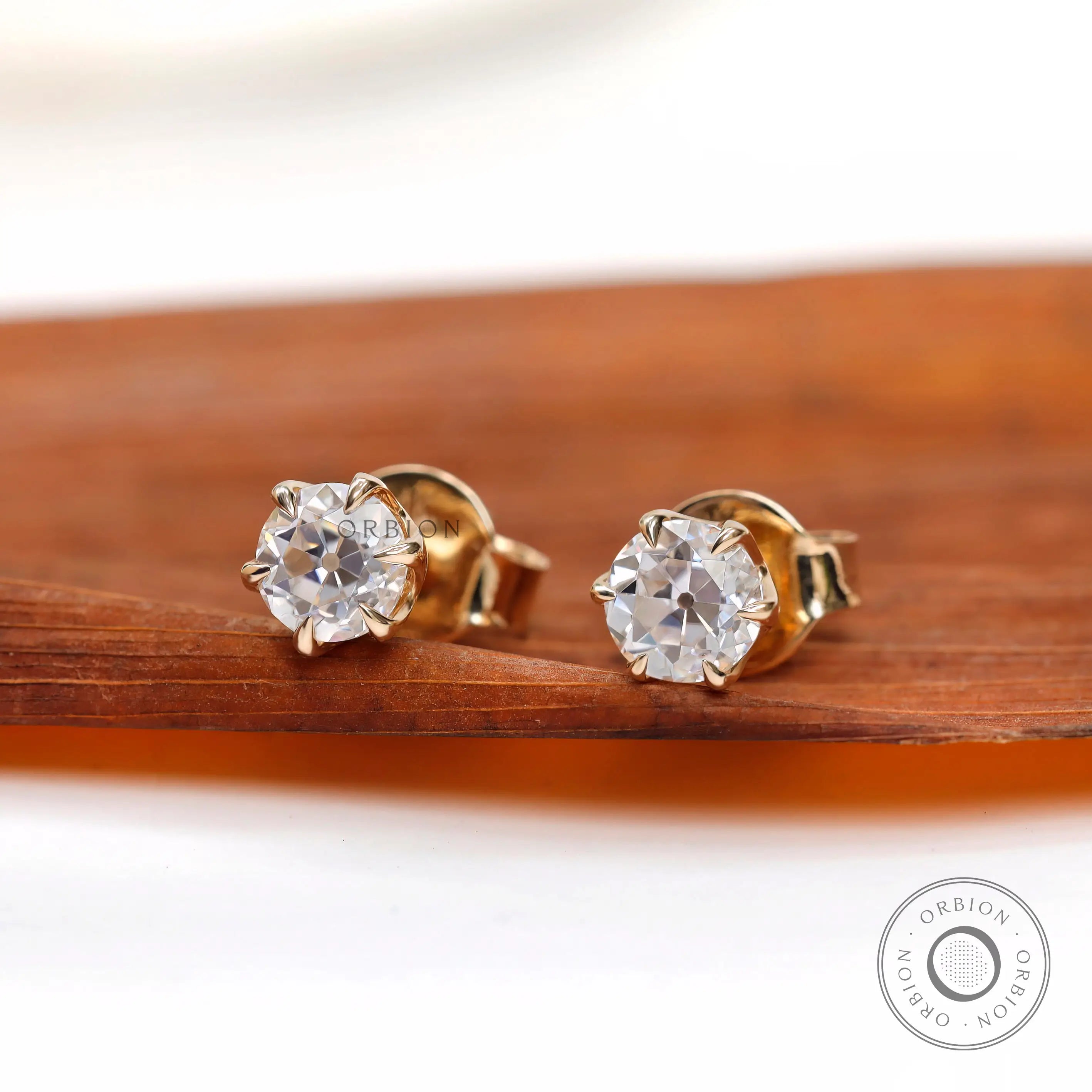 Angled view highlighting vintage cut moissanite brilliance of ear studs