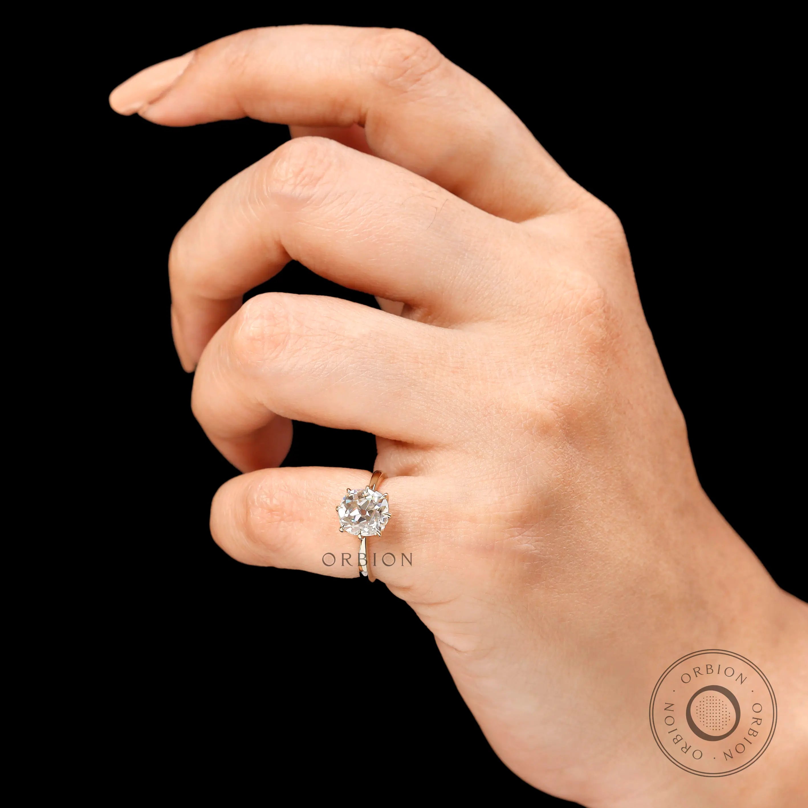 Prong setting detail of elongated cushion old mine cut solitaire ring in 14k yellow gold