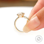 Hand shot of elongated cushion old mine cut lab diamond ring in 14k yellow gold