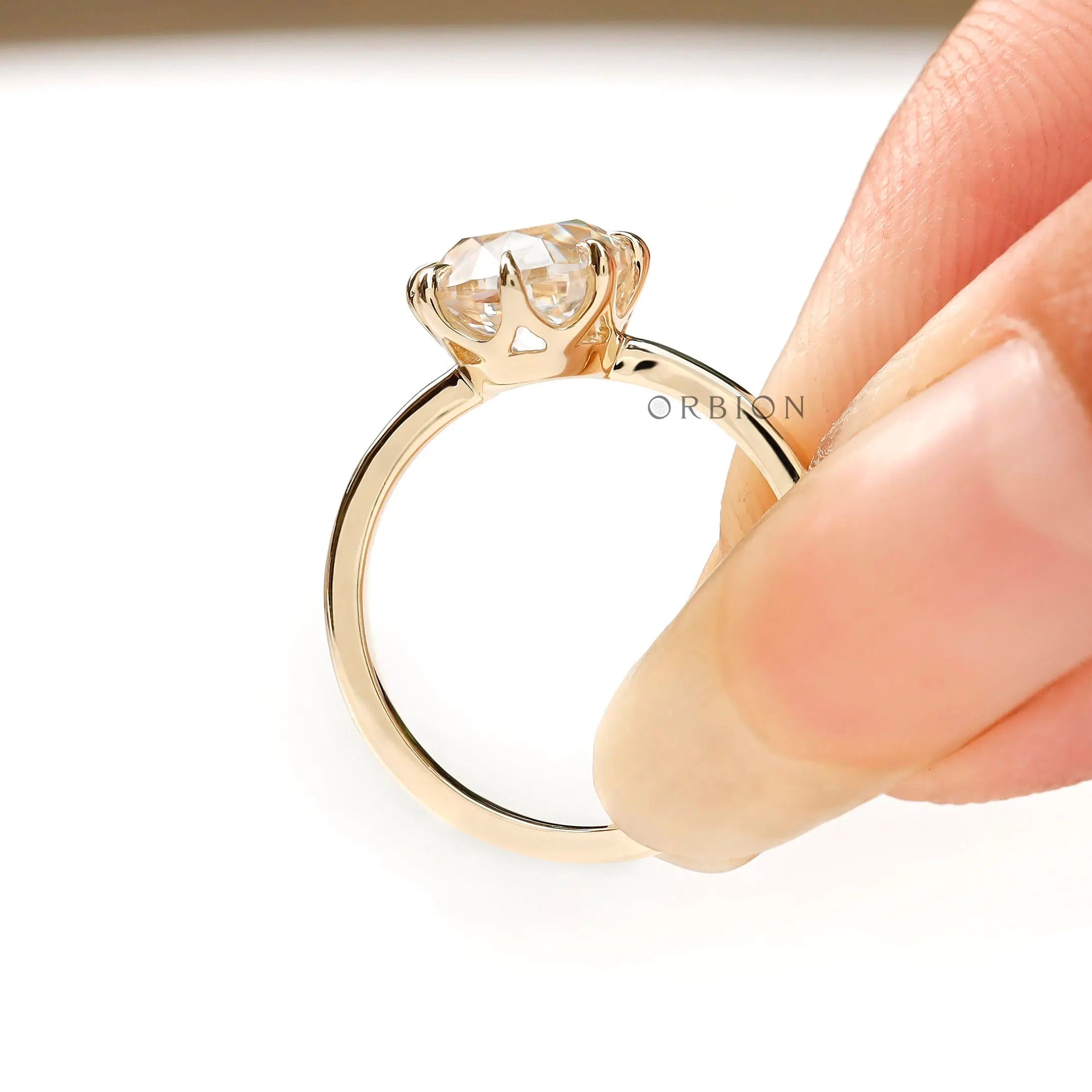 Hand shot of elongated cushion old mine cut lab diamond ring in 14k yellow gold