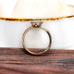 Classic engagement ring in 14k yellow gold with elongated cushion center stone