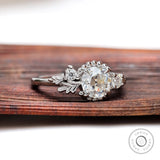 Art nouveau three stone engagement ring with round moissanite