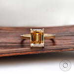 Emerald cut dark champagne moissanite solitaire ring yellow gold