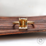 Emerald cut dark champagne moissanite solitaire ring yellow gold
