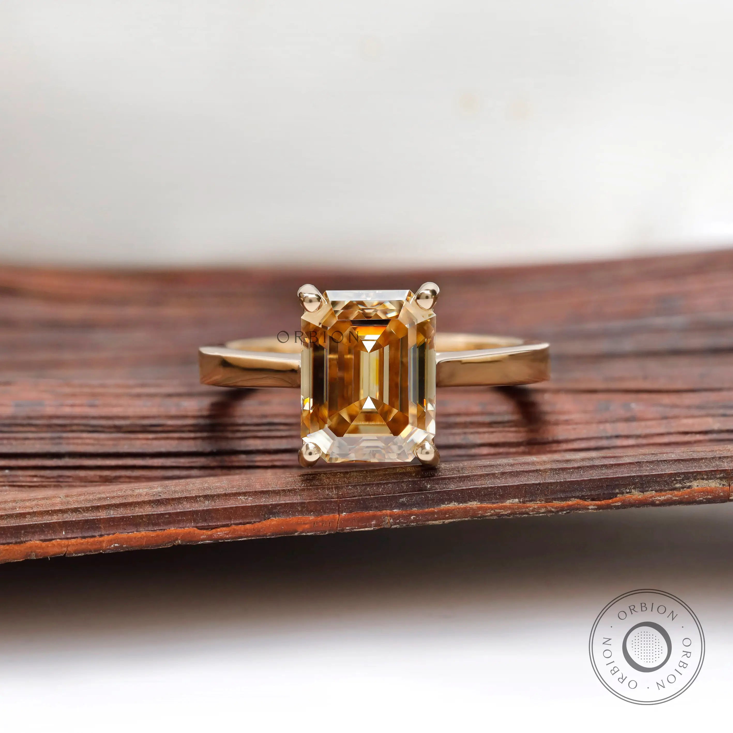 Emerald cut dark champagne moissanite solitaire ring yellow gold