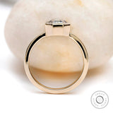 Side profile of octagon moissanite bezel set engagement ring