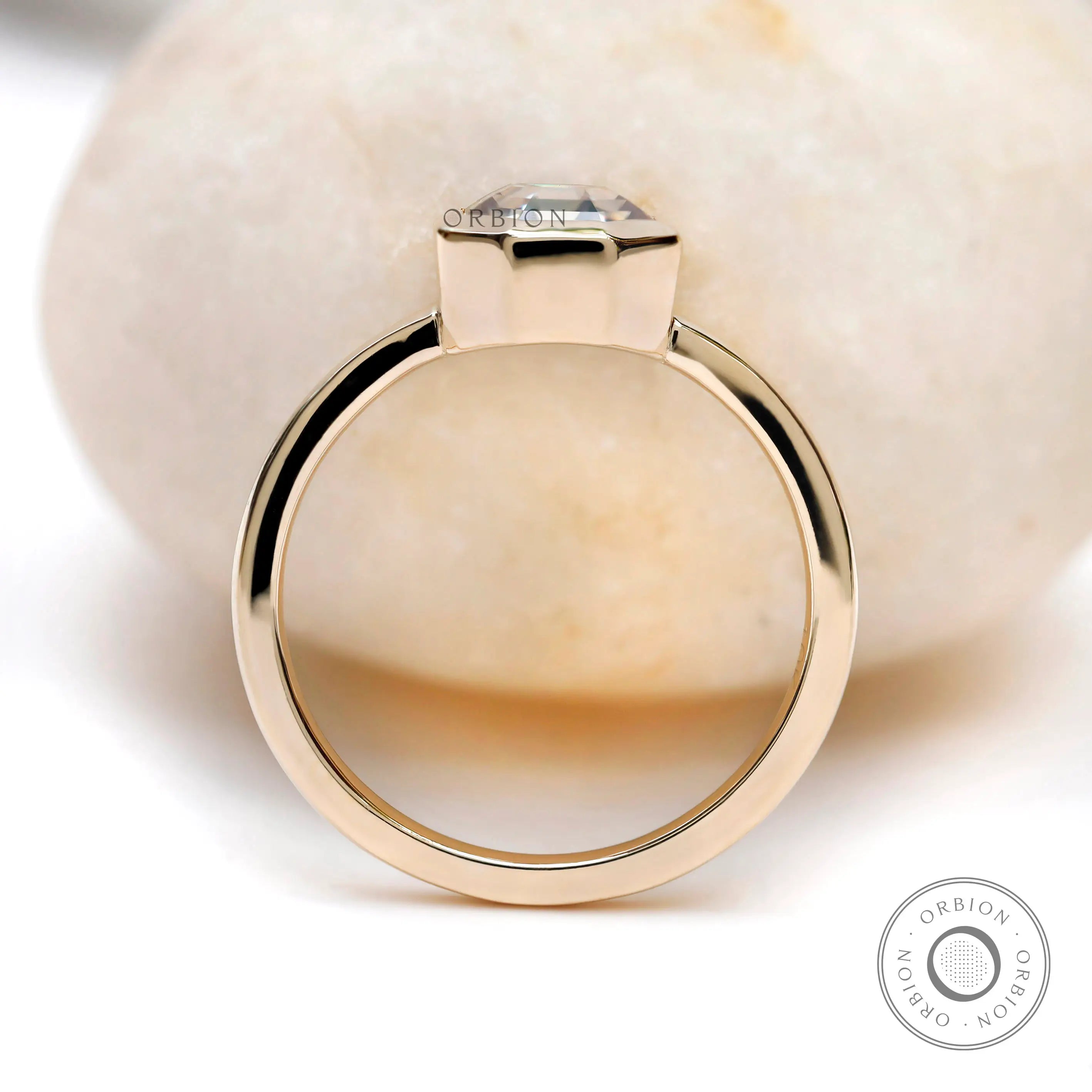 Side profile of octagon moissanite bezel set engagement ring