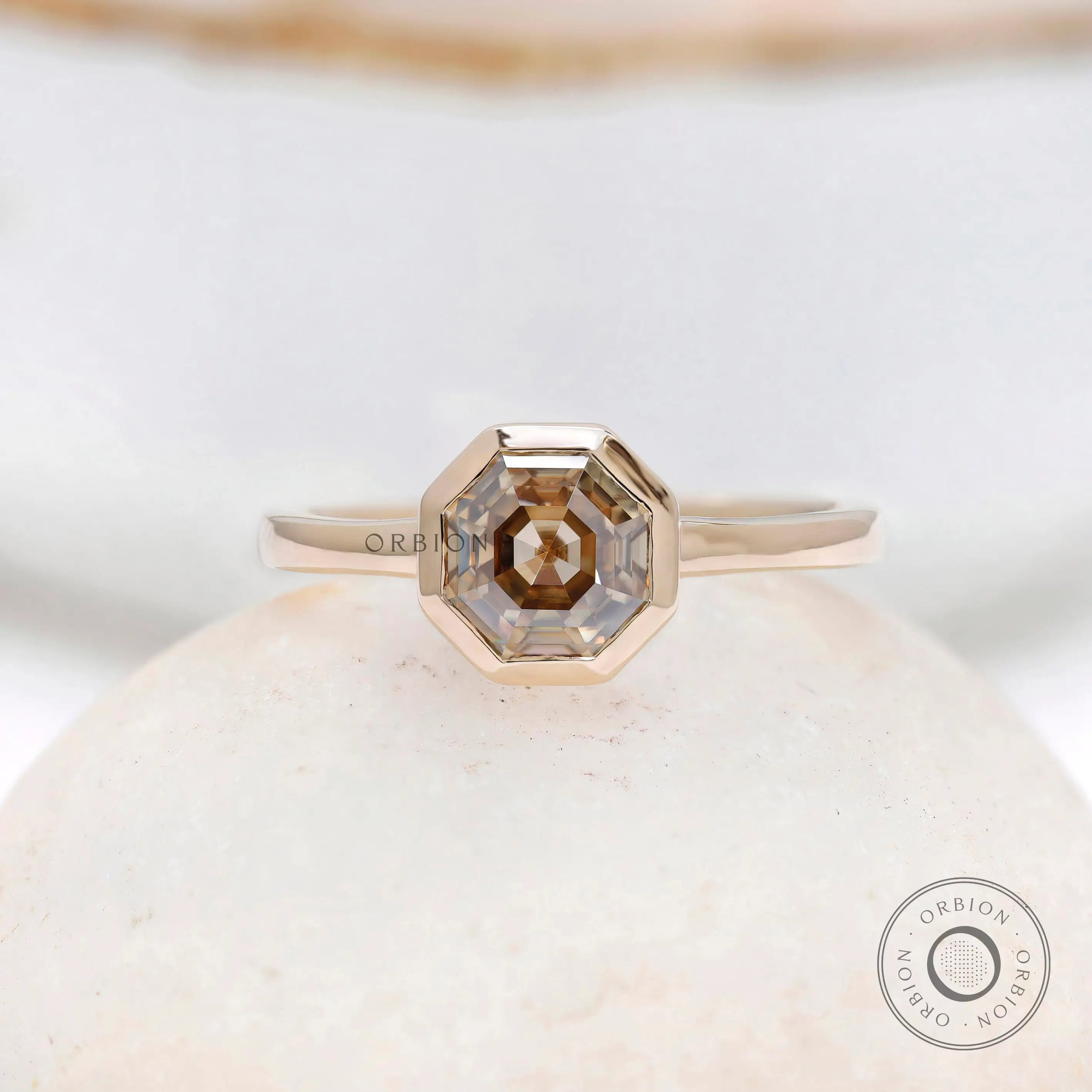 Minimalist octagon moissanite engagement ring with champagne stone close up