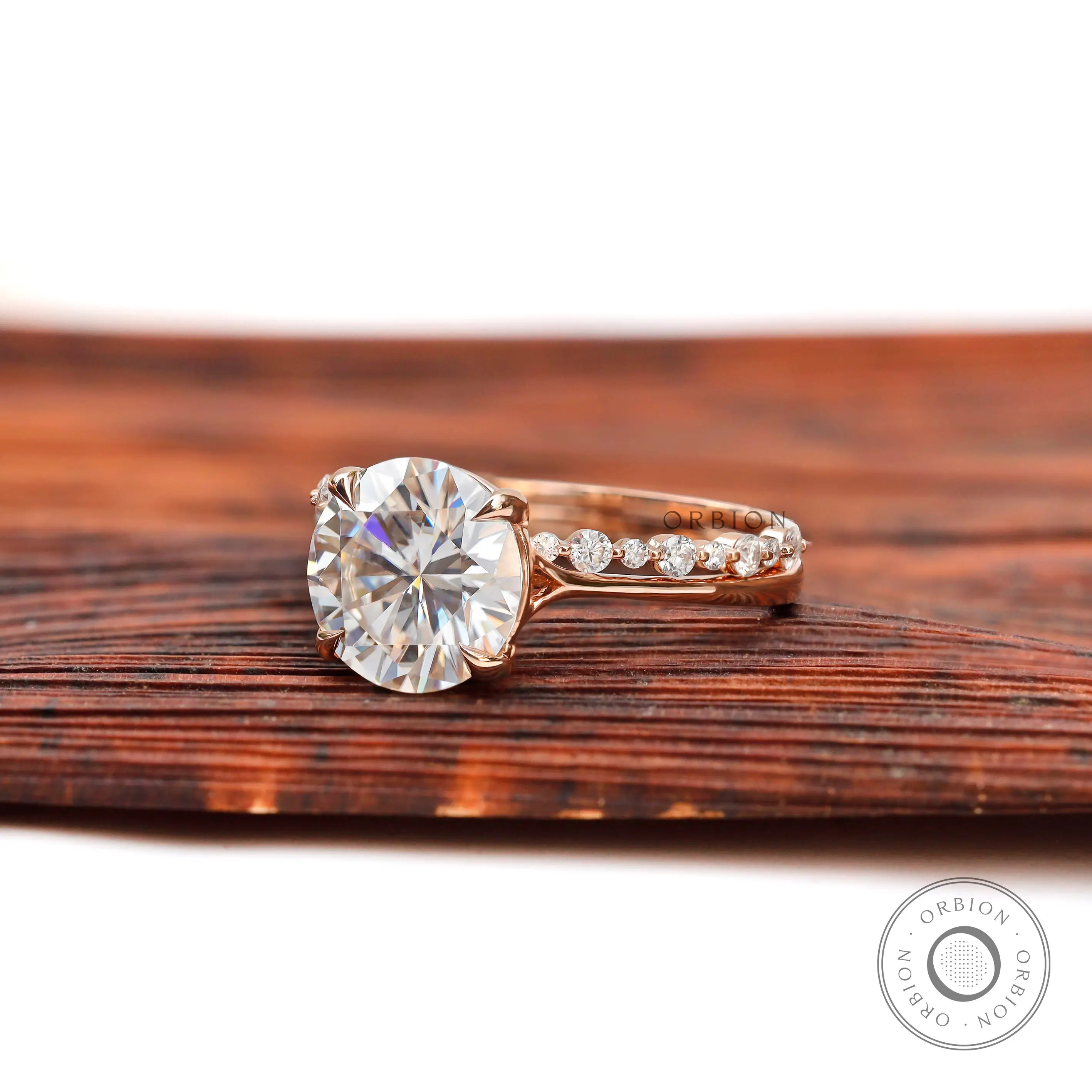 Cathedral set round brilliant moissanite engagement ring side view