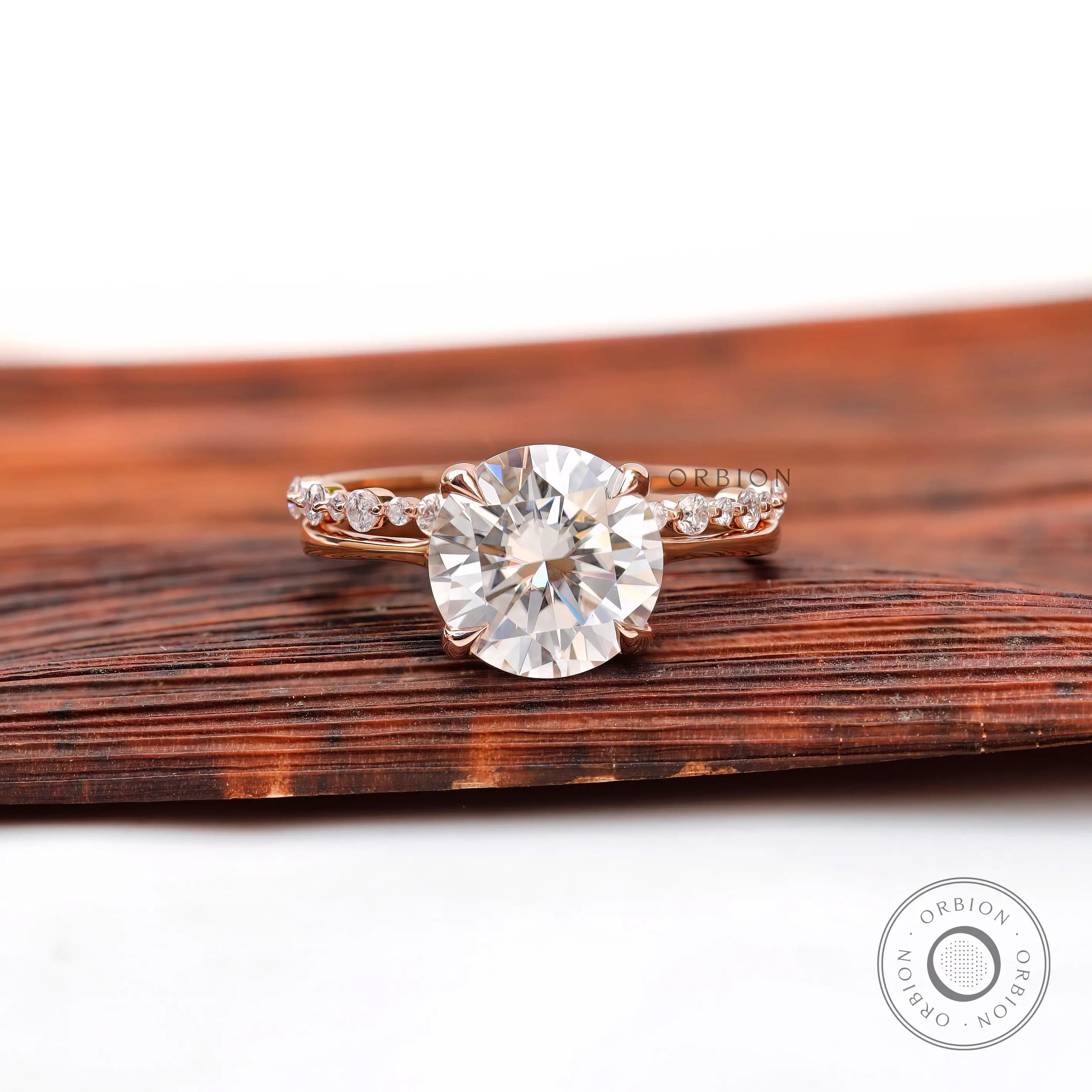 Round moissanite split shank engagement ring 14k rose gold top view