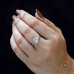 Minimalist three stone Asscher engagement ring on fingure