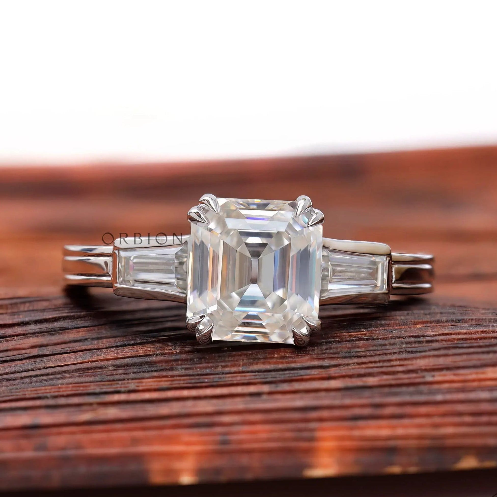 Asscher cut moissanite engagement ring with tapered baguette side stones