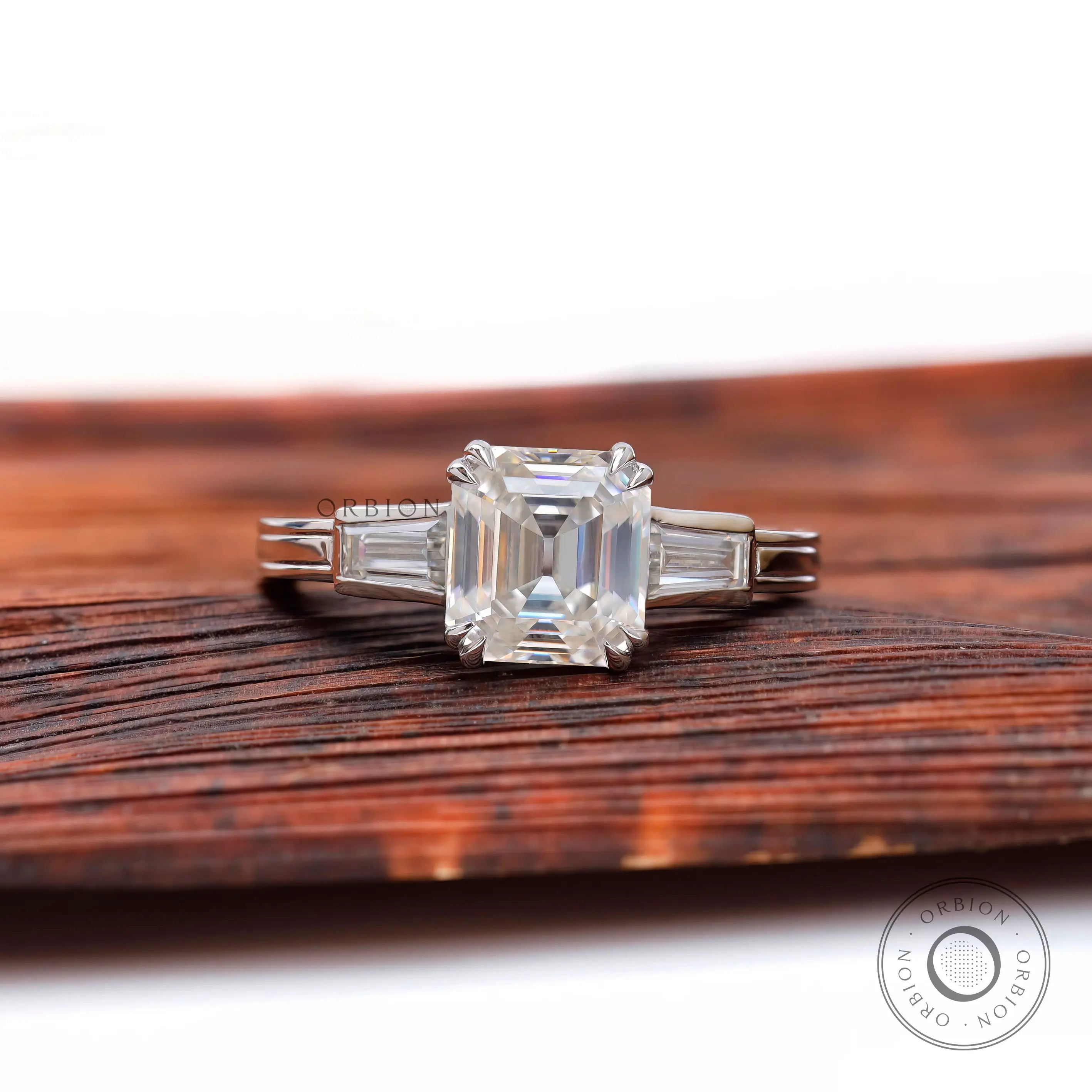 Asscher cut moissanite engagement ring with tapered baguette side stones