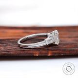 Tapered baguette side stone detail white gold ring