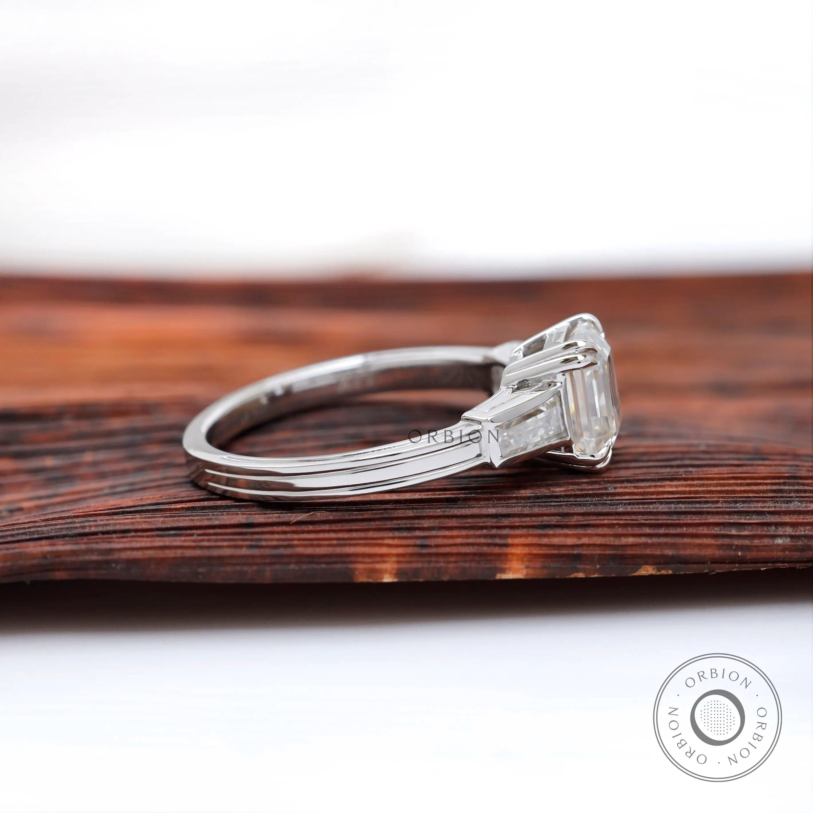 Tapered baguette side stone detail white gold ring