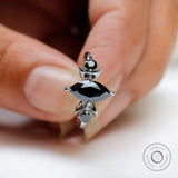 Close up of black marquise moissanite three stone celestial ring