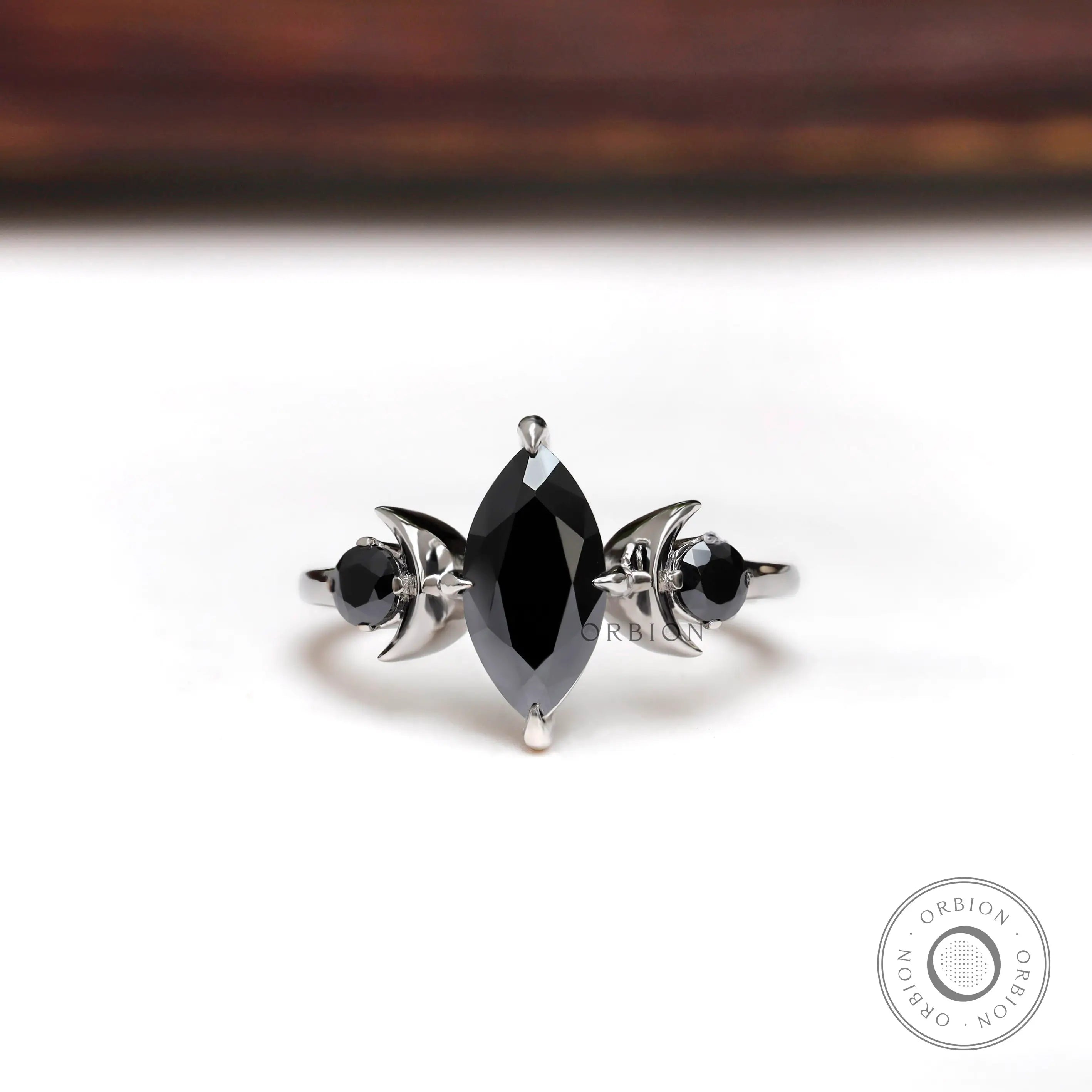 Black marquise moissanite three stone engagement ring 10K white gold front view